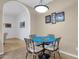 Cozy dining area featuring a round table with seating for four, with arched entry ways at 11775 E Becker Ln, Scottsdale, AZ 85259
