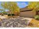 Charming home exterior with mature trees, desert landscaping, and a spacious driveway at 11775 E Becker Ln, Scottsdale, AZ 85259