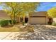Charming home featuring a well-maintained front yard with desert landscaping and mature desert trees at 11775 E Becker Ln, Scottsdale, AZ 85259