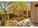 Front yard with desert landscaping, mature trees, and a walkway leading to the home at 11775 E Becker Ln, Scottsdale, AZ 85259