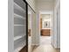 Hallway with closet and view of the bathroom with double vanities and wood cabinets at 11775 E Becker Ln, Scottsdale, AZ 85259