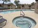 Inviting community jacuzzi and pool with sun loungers, modern patio, and secure fencing at 11775 E Becker Ln, Scottsdale, AZ 85259