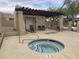 Inviting community jacuzzi, restroom building, sun loungers, and secure fencing at 11775 E Becker Ln, Scottsdale, AZ 85259