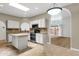 Well-lit kitchen showcases white cabinets, modern appliances, and adjacent dining area for seamless living at 11775 E Becker Ln, Scottsdale, AZ 85259