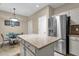 A well-equipped kitchen featuring granite island, stainless refrigerator, and eating area at 11775 E Becker Ln, Scottsdale, AZ 85259