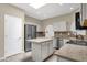 A bright kitchen featuring stainless steel appliances, granite countertops, and kitchen island at 11775 E Becker Ln, Scottsdale, AZ 85259