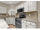 Well-appointed kitchen with stainless steel appliances, granite countertops, and white cabinets at 11775 E Becker Ln, Scottsdale, AZ 85259