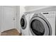 Laundry room equipped with modern washer and dryer units for convenience at 11775 E Becker Ln, Scottsdale, AZ 85259