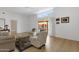 Inviting living room with wood floors, neutral furniture, and large window for natural light at 11775 E Becker Ln, Scottsdale, AZ 85259