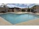 Inviting community pool with a jacuzzi, modern patio, and shaded lounging areas at 11775 E Becker Ln, Scottsdale, AZ 85259