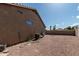 Expansive gravel backyard with functional AC unit and ample space for outdoor activities and customization at 1207 E Clearview Dr, Casa Grande, AZ 85122