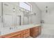 Bright bathroom with dual sinks, vanity lighting, and soaking tub at 1207 E Clearview Dr, Casa Grande, AZ 85122