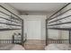 View between two bunk beds looking at closet with wood-look flooring and white bi-fold doors at 1207 E Clearview Dr, Casa Grande, AZ 85122