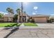 Beautiful home featuring a well-manicured lawn, desert landscaping, and an attached two-car garage at 1207 E Clearview Dr, Casa Grande, AZ 85122