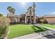 Inviting single-story home featuring lush landscaping, a wide driveway, and a two-car garage at 1207 E Clearview Dr, Casa Grande, AZ 85122