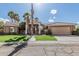 Inviting single-story home featuring lush landscaping, a wide driveway, and a two-car garage at 1207 E Clearview Dr, Casa Grande, AZ 85122