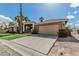 Garage and entrance to a home with a desert landscaped yard on a clear, sunny day at 1207 E Clearview Dr, Casa Grande, AZ 85122