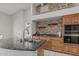 Kitchen with brick wall accent, granite counters and stainless oven at 1207 E Clearview Dr, Casa Grande, AZ 85122