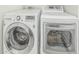 Modern laundry room featuring a front-loading washing machine and dryer at 1207 E Clearview Dr, Casa Grande, AZ 85122
