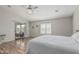 Bright main bedroom with ceiling fan, hardwood floors, and backyard access at 1207 E Clearview Dr, Casa Grande, AZ 85122