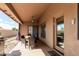 Cozy covered patio with outdoor dining and lounging area with outdoor ceiling fan at 1207 E Clearview Dr, Casa Grande, AZ 85122