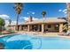 Backyard featuring a sparkling pool and palm trees, perfect for outdoor entertaining at 1207 E Clearview Dr, Casa Grande, AZ 85122