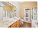 Bathroom with double vanity, walk-in shower, soaking tub, and a door to the backyard at 12626 W Windsor Ave, Avondale, AZ 85392