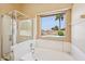 Bathroom featuring a shower, soaking tub, and large window overlooking the backyard pool at 12626 W Windsor Ave, Avondale, AZ 85392