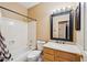 Neutral-toned bathroom featuring a shower-tub combo and a large framed mirror above the vanity at 12626 W Windsor Ave, Avondale, AZ 85392