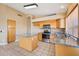 Open kitchen featuring wooden cabinets, an island with granite countertops, and stainless steel appliances at 12626 W Windsor Ave, Avondale, AZ 85392