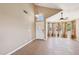 Bright living room with tile flooring, ceiling fan, and large bay window with decorative curtains at 12626 W Windsor Ave, Avondale, AZ 85392
