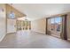 Bright living room with tile flooring, high ceilings, and large windows with decorative curtains at 12626 W Windsor Ave, Avondale, AZ 85392