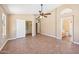 Spacious main bedroom with tile flooring, ceiling fan, closet, and a bathroom with dual sinks at 12626 W Windsor Ave, Avondale, AZ 85392