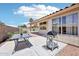Back patio featuring a BBQ grill, outdoor table and mature landscaping at 12626 W Windsor Ave, Avondale, AZ 85392