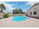 Backyard pool with concrete surround, rock waterfall, and mature landscaping at 12626 W Windsor Ave, Avondale, AZ 85392