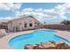 Backyard pool featuring a rock surround, blue water, and a diving platform at 12626 W Windsor Ave, Avondale, AZ 85392