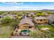 Stunning aerial view showcasing a home with a private pool and lush landscaping in a serene neighborhood at 12702 W Dove Wing Way, Peoria, AZ 85383