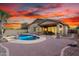 Gorgeous backyard features a pool, spa, and covered patio area, perfect for entertaining at 12702 W Dove Wing Way, Peoria, AZ 85383