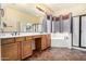 Bright bathroom with double vanity, soaking tub, and a separate shower, designed for relaxation and convenience at 12702 W Dove Wing Way, Peoria, AZ 85383