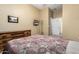 The bedroom has a window with a dresser, a mounted TV, and carpet at 12702 W Dove Wing Way, Peoria, AZ 85383