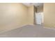 Empty bedroom featuring neutral carpeting and a walk-in closet at 12702 W Dove Wing Way, Peoria, AZ 85383