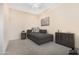 Comfortable bedroom featuring a chaise lounge, dresser, and soft neutral tones at 12702 W Dove Wing Way, Peoria, AZ 85383