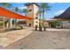 Elegant community center showcasing modern design with shaded outdoor areas, palm trees and inviting landscape at 12702 W Dove Wing Way, Peoria, AZ 85383