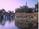 Beautiful community entrance with stone signage, a waterfall feature and desert landscaping reflecting natural beauty at 12702 W Dove Wing Way, Peoria, AZ 85383