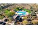 Aerial view of a community pool area with shade structures, lounge chairs and desert landscaping at 12702 W Dove Wing Way, Peoria, AZ 85383