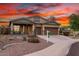 Charming single-Gathering home featuring desert landscaping, a three-car garage, and a welcoming front porch at 12702 W Dove Wing Way, Peoria, AZ 85383