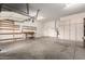 Spacious garage with work bench, shelving, storage cabinets, and epoxy floors at 12702 W Dove Wing Way, Peoria, AZ 85383