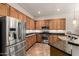 Well-equipped kitchen with stainless steel appliances, granite countertops, and ample cabinet space at 12702 W Dove Wing Way, Peoria, AZ 85383