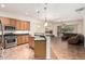 Open-concept kitchen with an island, stainless steel appliances, and a seamless transition to the living area at 12702 W Dove Wing Way, Peoria, AZ 85383