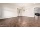Bright, open living space with tile floors, neutral walls, and stylish chandelier at 12702 W Dove Wing Way, Peoria, AZ 85383